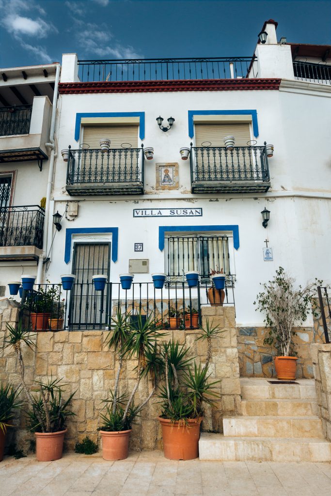 White house with blue ornaments in Santa Cruz District in Alicante, Spain