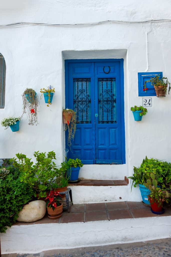 Whitewashed building with blue doors in Frigiliana, Spaian