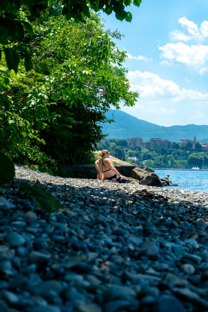 Water activities around Lake Geneva - sunbathing on a pebbly beach in Thonon