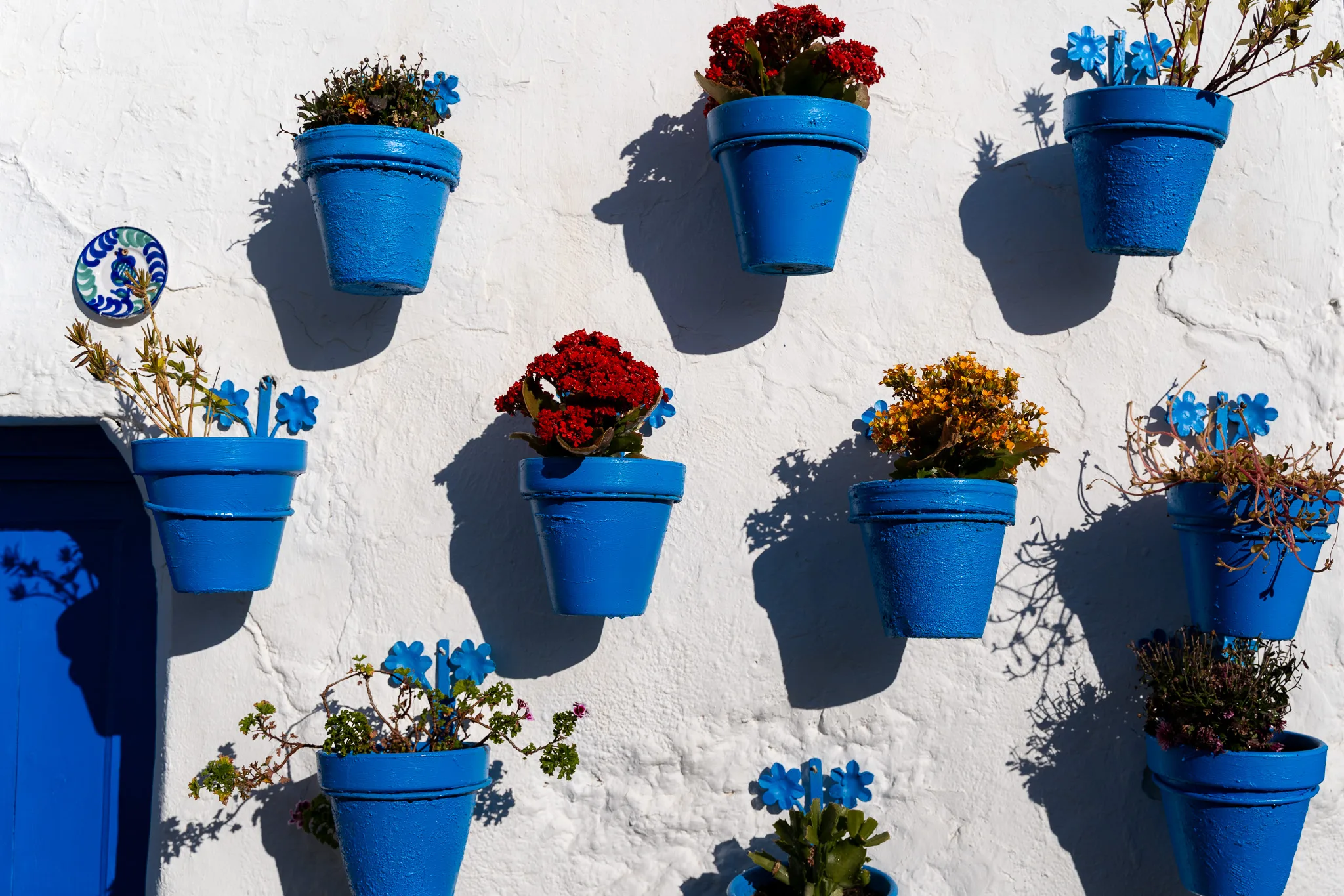 Colorful pots in Patio de las Comedias in Iznajar, Spain